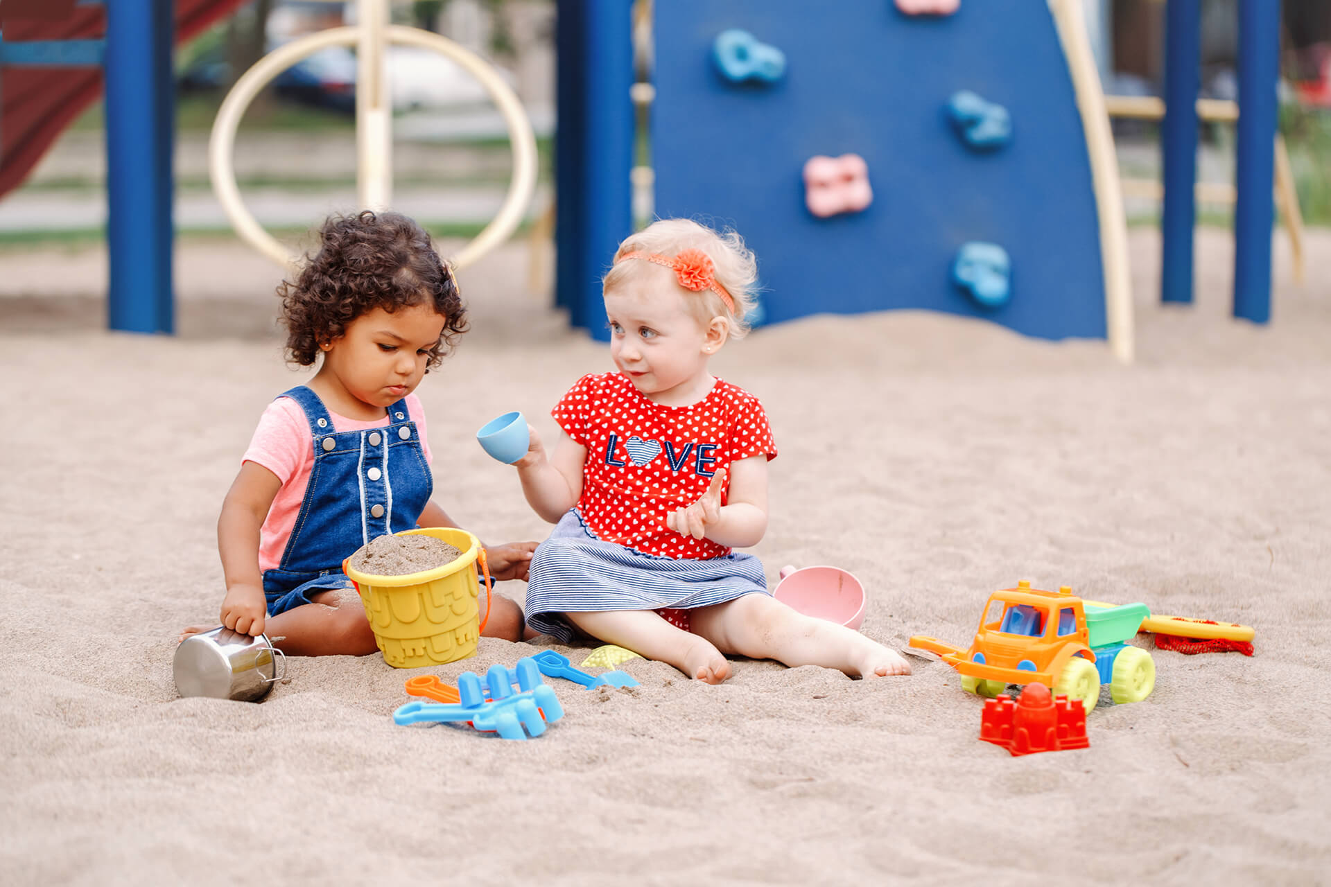 two kids playing in sand